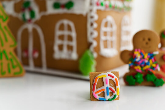 Gingerbread Peace Sign by a Decorated Gingerbread House
