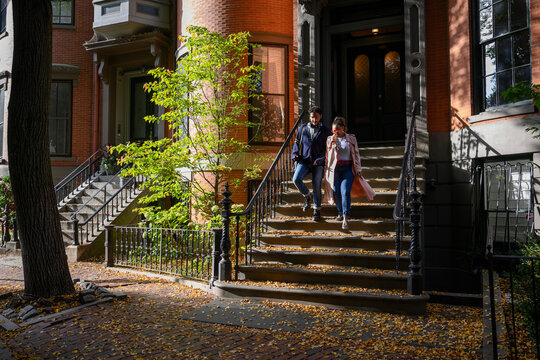 Young African American Couple Walking in Boston Neighborhood with Brownstone