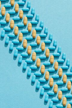 Pills in rows on blue