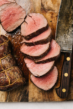 Cutting cooked beef tenderloin into medallions