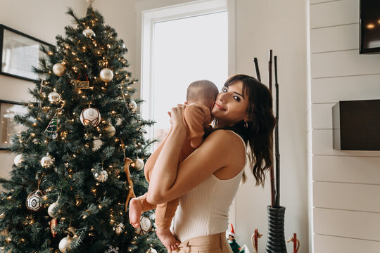 Mom and Baby in Front of Christmas Tree