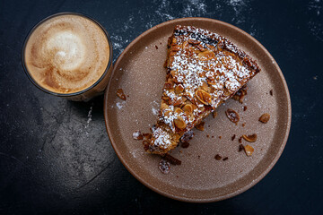 Cake with nuts on a plate and Coffee with milk 