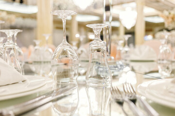 Mirror table festive setting in luxury restaurant. Glasses, plates, cutlery on mirror table. shallow depth of field