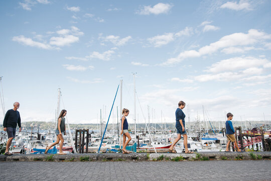 Grandparents and grandchildren walking in a line together in fro