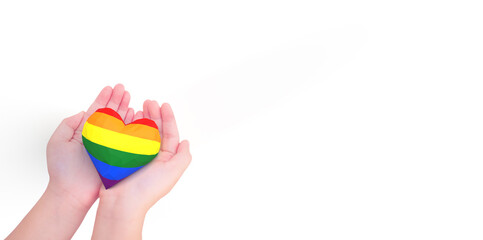 lgbtq rainbow heart on girl hands isolated white.Rainbow flag background.New LGBTQ+ Rights Pride Flag.Diverse diversity equality.Proud, give, protect design support and proud LGBTQ month.gay day.