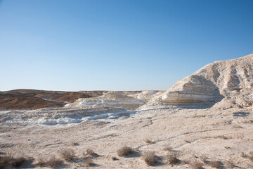 Beautiful lunar landscape. Wight and smooth hills in various shapes in a desert landscape. The whitish, rounded, winding, and smooth chalk rocks. Israel. High quality photo