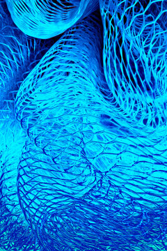 macro of plastic mesh fabric, color-altered to cyan blue