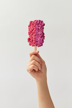 Female hand holding brain ice cream
