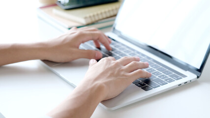 Close up of man hand typing laptop computer while working at home office, Student college online study, learning, people and technology
