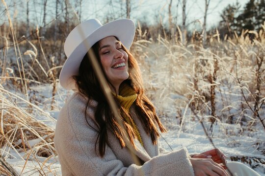 Happy woman laughing in winter countryside
