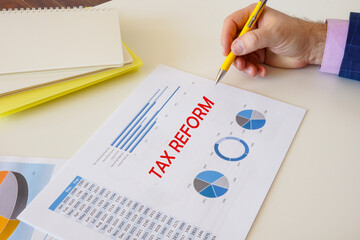 Financial concept meaning TAX REFORM with sign on the page.