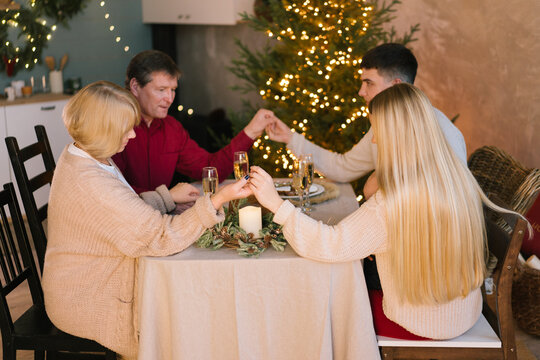 Cheerful family gathering and celebrating New Year at home