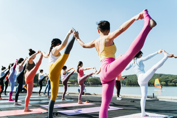 Young women practice yoga in the park