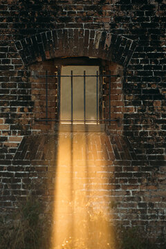 Golden Light Shining Through Barred Window