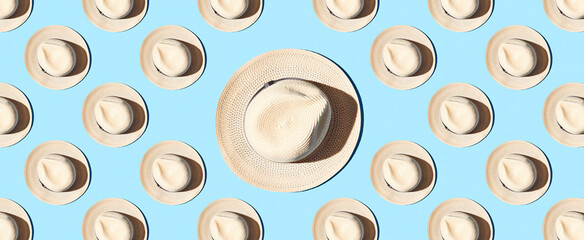 Pattern of straw hats on blue pastel background