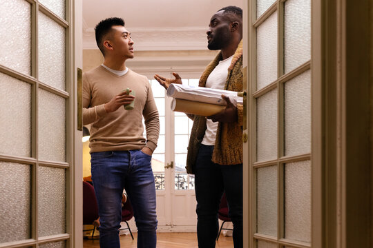 Focused multiethnic men discussing project together