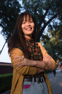 Smiling woman wearing gold statement jewelry