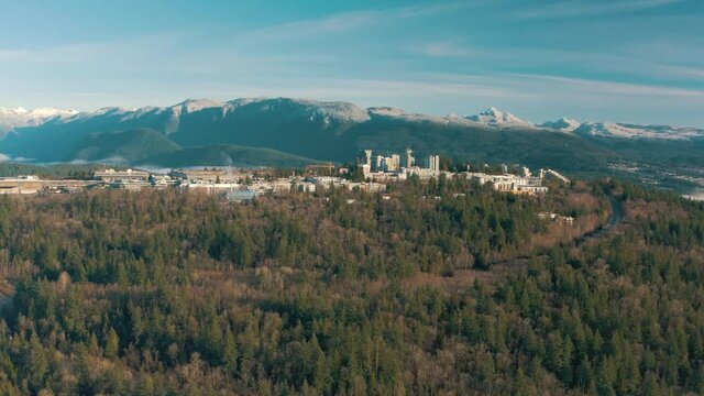 Aerial view of Simon Fraser University on a hill and mountains on background in British Columbia, Vancouver, Canada
