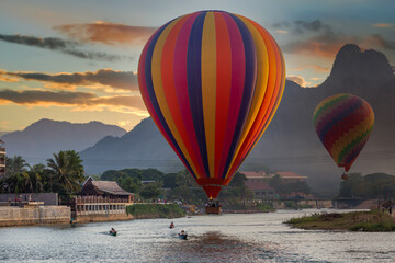 Nam Song river at sunset with hot air balloon in Vang Vieng, Laos, Beautifull landscape on the Nam...