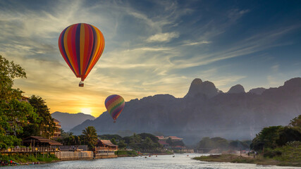 Nam Song river at sunset with hot air balloon in Vang Vieng, Laos, Beautifull landscape on the Nam...