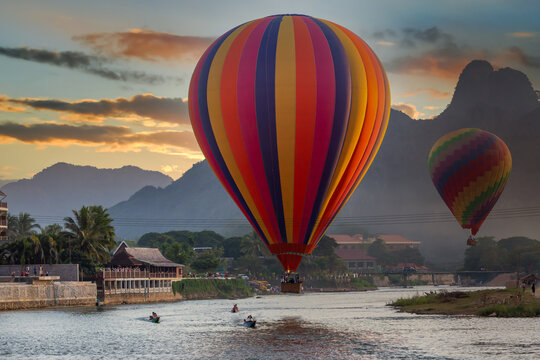 Nam Song river at sunset with hot air balloon in Vang Vieng, Laos, Beautifull landscape on the Nam Song River in Vang Vieng, Laos.