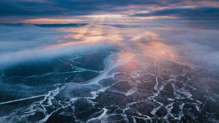 dramatic sunset above frozen river
