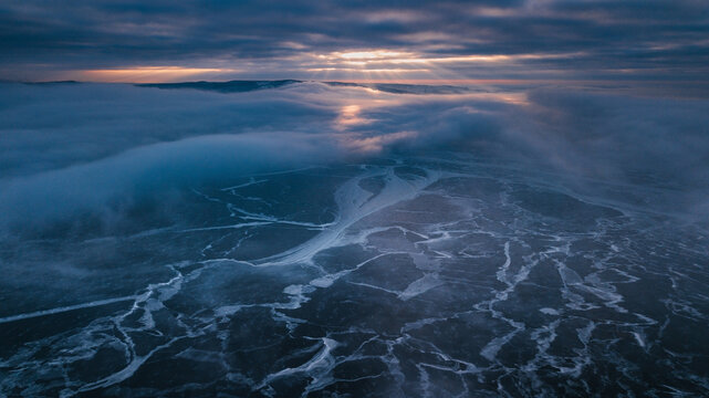 dramatic sunset above frozen river