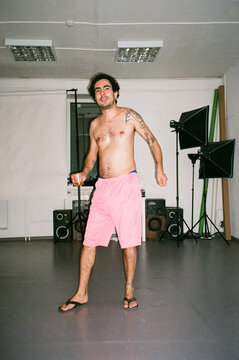 shirtless latin / afro man dancing during a party in a photo studio