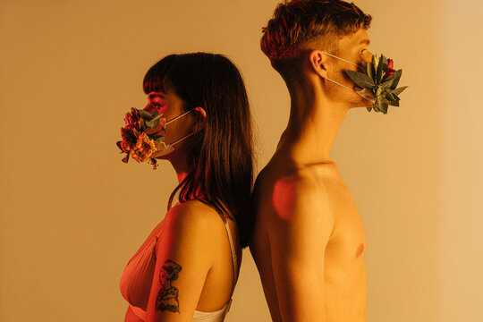 back to back couple wearing flower masks