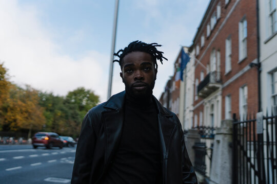Handsome Balck Man Walking Down the Street Looking BAck