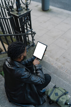Afrom Man using Digital Tablet Outdoors