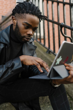 Afrom Man using Digital Tablet Outdoors