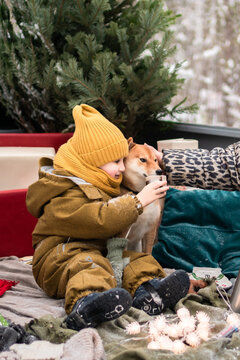 Child sharing drink with dog