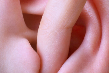 finger in ear closeup