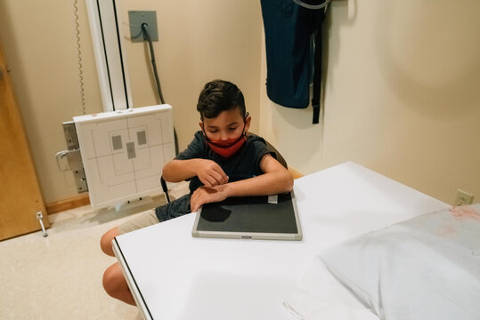 10-year-old boy getting x-ray of arm. 
