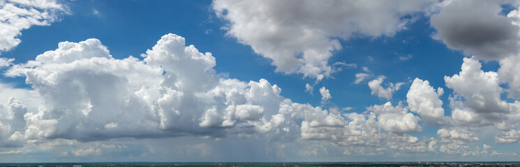 blue sky background with tiny clouds. panorama white fluffy clouds in the blue sky.Beautiful vast blue sky with amazing cloud background.Wide sky panorama with scattered cumulus clouds.