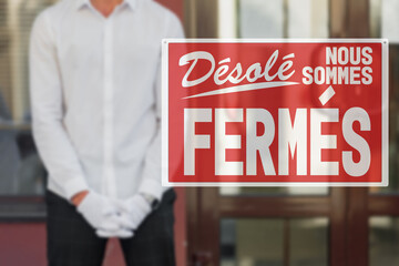 sorry we are closed lettering in french. Sorry we're closed sign outside restaurant during covid-19 lockdown