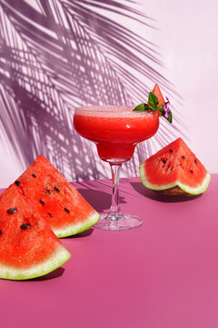 Watermelon cocktail on the table with sun shadows. Tropical concept.