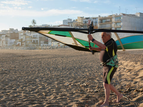 Aged sportsman preparing for windsurf