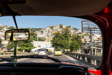 Road trip in a red car in an empty highway with point of view from the inside. 