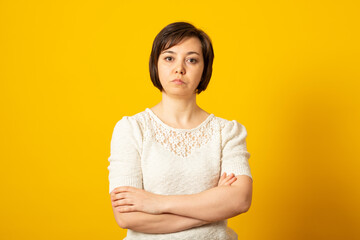 Obraz premium Angry grumpy female dressed casually keeping arms folded, looking at camera with strict and skeptical expression, doesn't believe excuses of her unfaithful boyfriend.