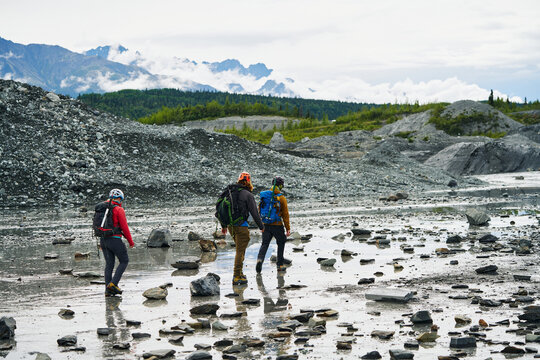 Alpinist group of friends walking over Alaska natural landscape