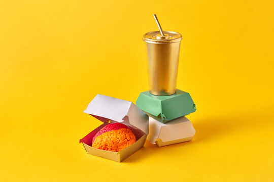 Colored brain in food paper box near drink