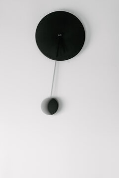 Black pendulum clock with slow shutter speed mouvement 