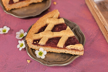 Slice of pie called 'Linzer Torte', a traditional Austrian shortcake pastry topped with fruit...