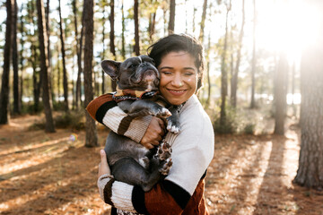 A woman embracing her dog - pregnancy announcement 