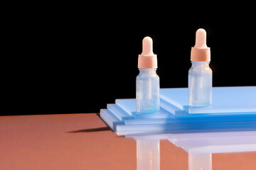 Glass dropper bottles with a pipette with rubber tip on the beautiful shadow