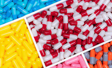 Top view of colorful capsule pills in plastic tray. Pharmaceutical industry. Healthcare and...