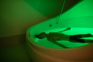 Asian man in float tank