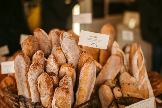 Baskets with fresh baguettes in bakery
